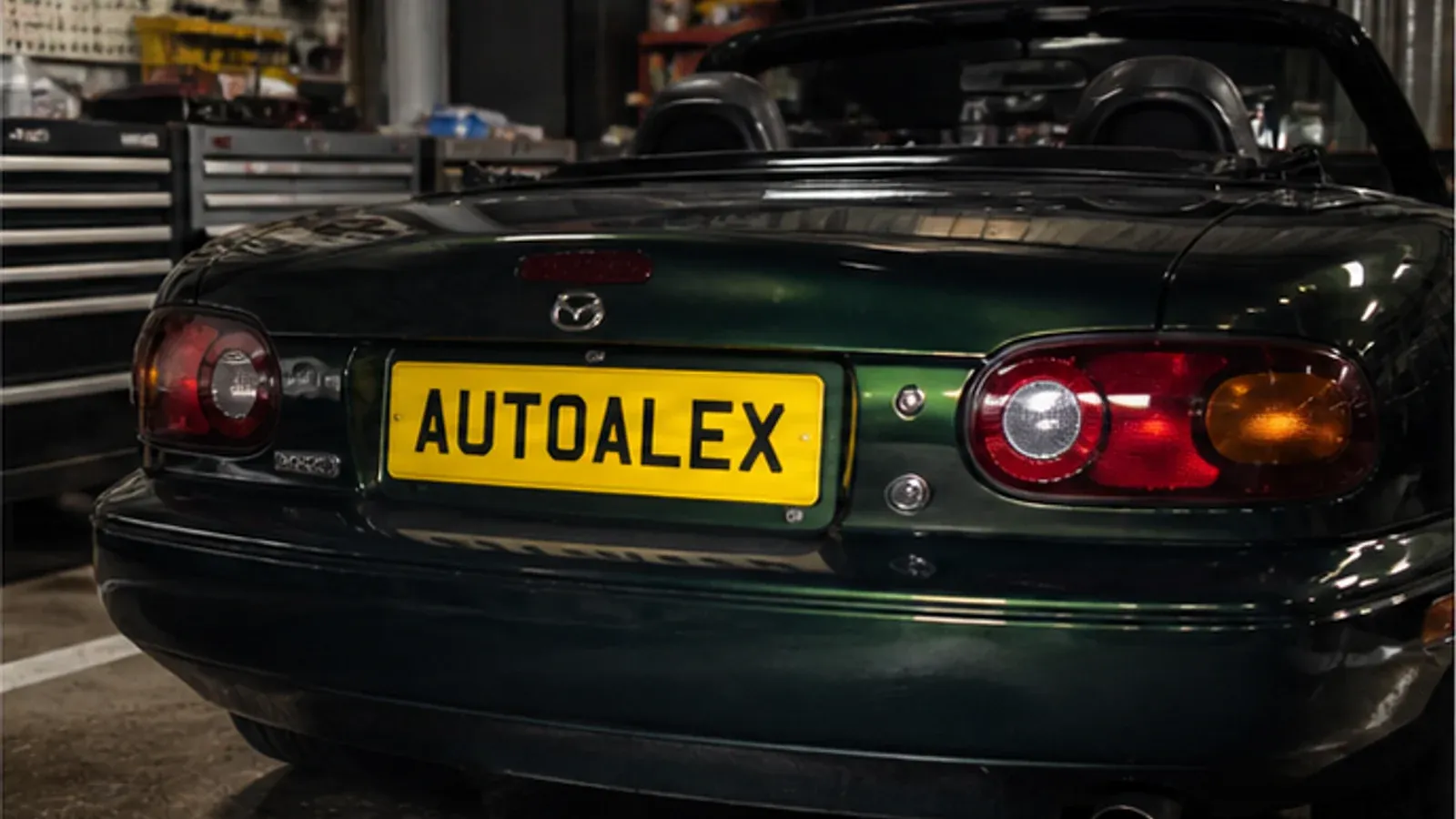 Mazda MX-5 in a workshop with an AutoAlex-inspired number plate