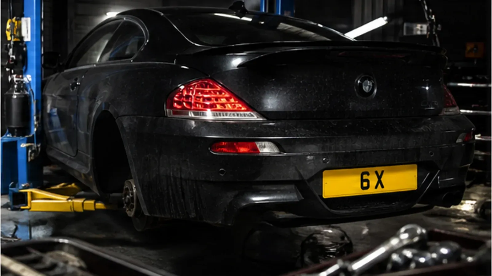 BMW 6 Series in a workshop with 6X number plate