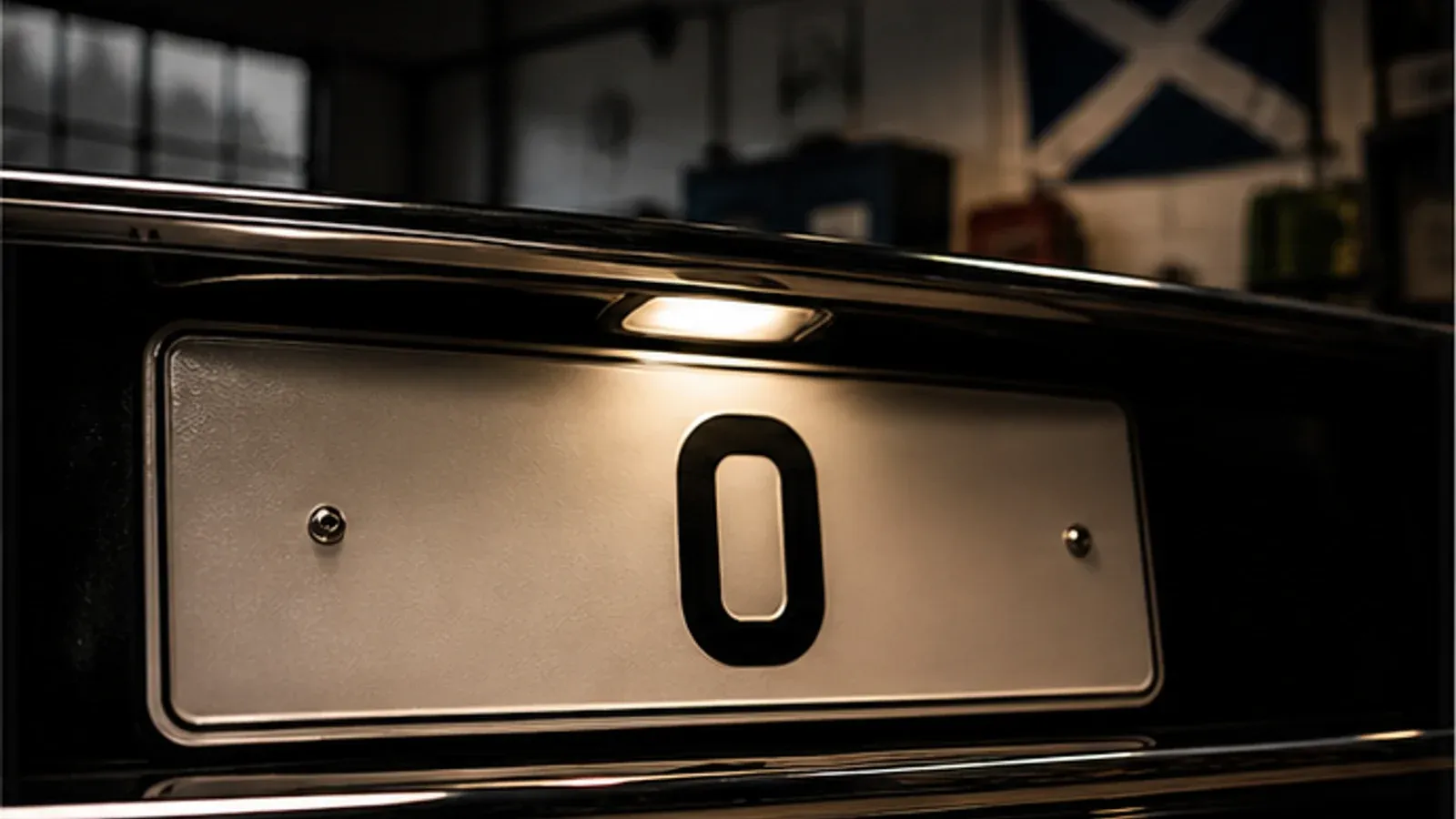 Close-up of a rare zero number plate on a dark luxury vehicle